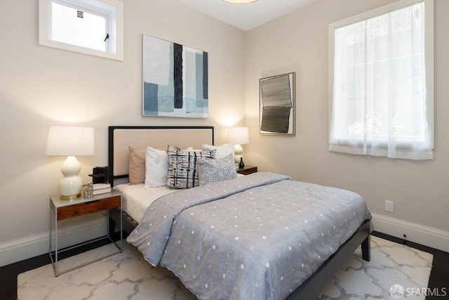 bedroom with multiple windows and baseboards