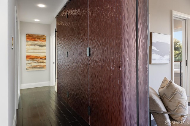 hallway with baseboards and dark wood finished floors