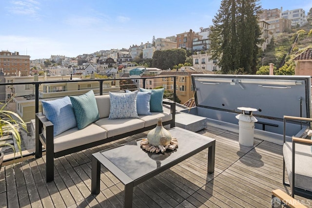 deck featuring outdoor lounge area and a view of city