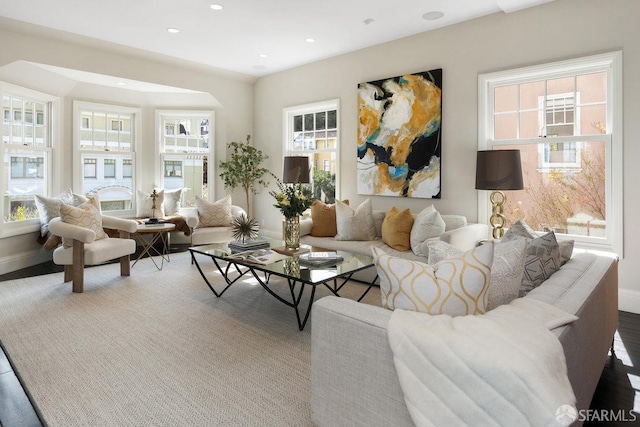 living area featuring recessed lighting, baseboards, and wood finished floors