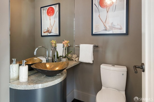 bathroom with toilet and a sink