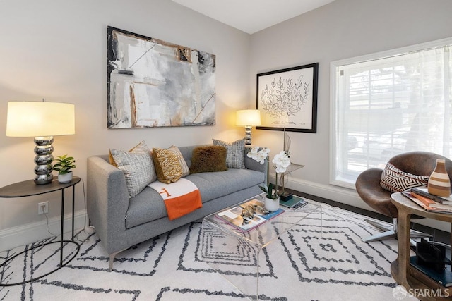 living area featuring baseboards