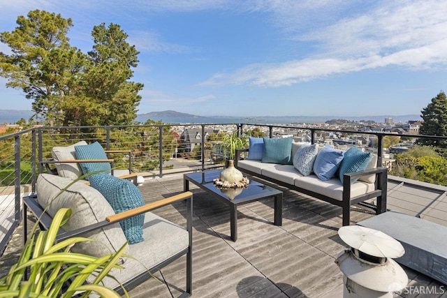 deck featuring an outdoor living space and a mountain view