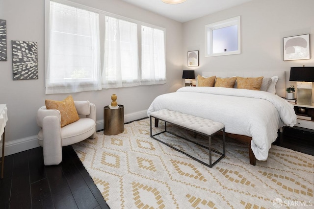 bedroom featuring wood finished floors and baseboards