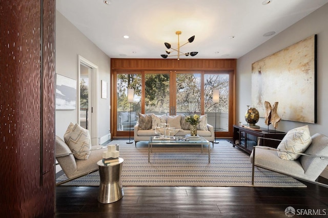 living room with recessed lighting, baseboards, a notable chandelier, and hardwood / wood-style flooring