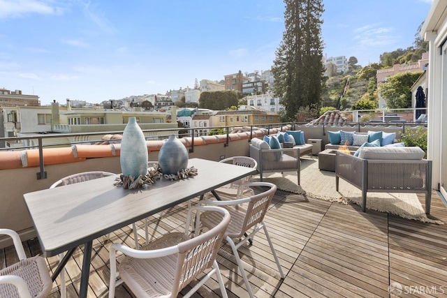 wooden terrace featuring outdoor dining space and outdoor lounge area