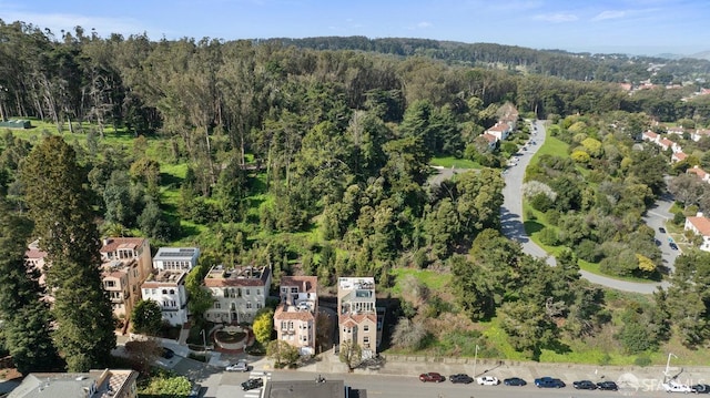 bird's eye view with a wooded view