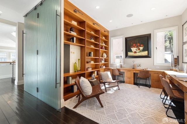 sitting room with recessed lighting, baseboards, light wood-style flooring, and built in desk