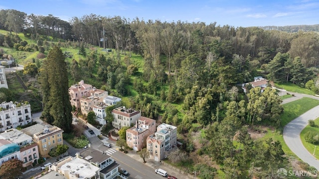 drone / aerial view featuring a wooded view