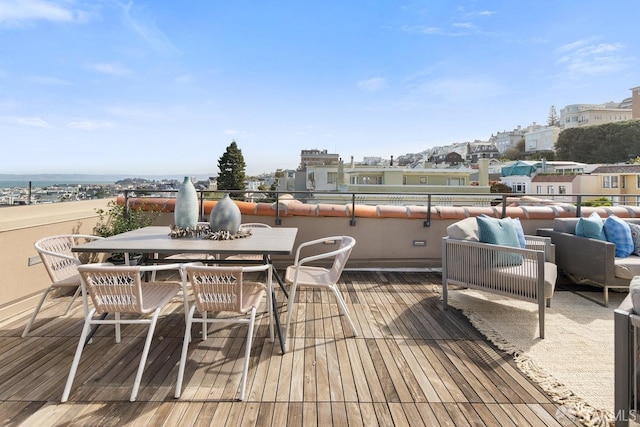 wooden deck featuring a view of city and outdoor dining space