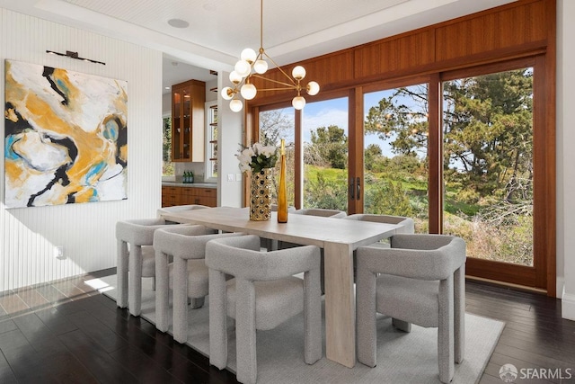 dining area with a notable chandelier and dark wood-type flooring