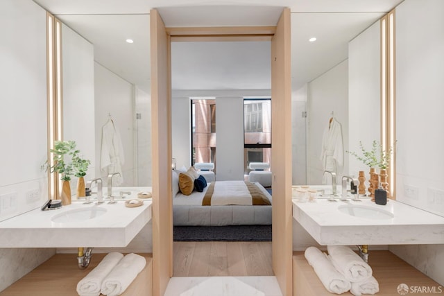 full bathroom featuring a walk in shower, recessed lighting, wood finished floors, and connected bathroom