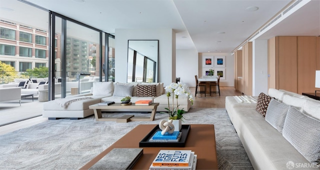 living area with a wall of windows and wood finished floors