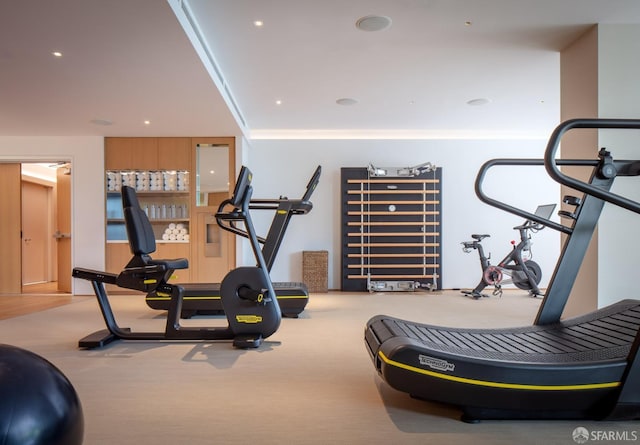 exercise room featuring carpet floors, crown molding, and recessed lighting