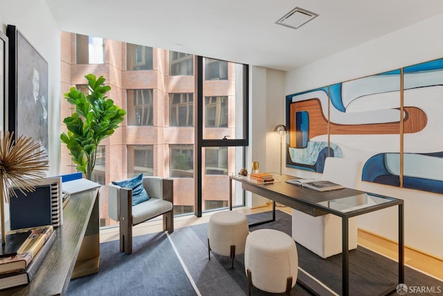 office area featuring a wall of windows and visible vents