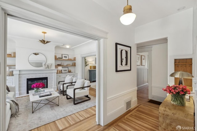 1383 8th Ave, San Francisco, CA 94122 - living area with wood finished floors, a glass covered fireplace, and crown molding