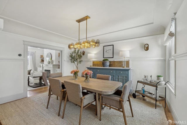 1383 8th Ave, San Francisco, CA 94122 - dining area featuring a fireplace, light wood finished floors, and baseboards