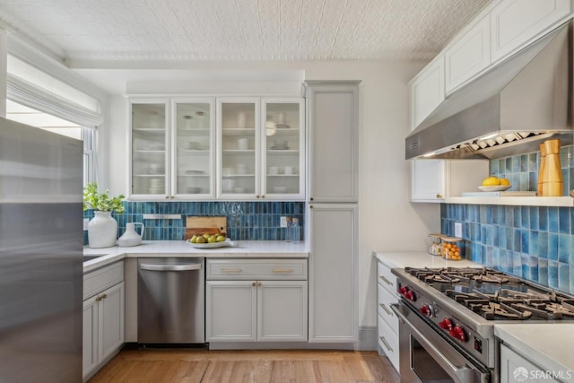 1383 8th Ave, San Francisco, CA 94122 - kitchen featuring extractor fan, appliances with stainless steel finishes, gray cabinets, and backsplash