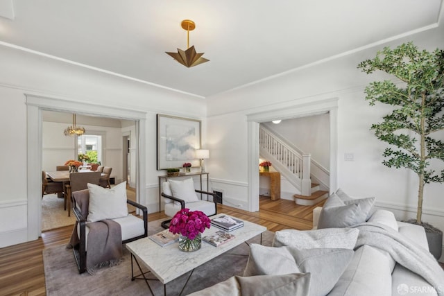 1383 8th Ave, San Francisco, CA 94122 - living room featuring stairway, wood finished floors, wainscoting, and a chandelier
