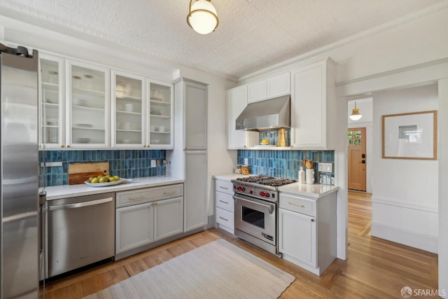 1383 8th Ave, San Francisco, CA 94122 - kitchen featuring extractor fan, appliances with stainless steel finishes, light countertops, and tasteful backsplash