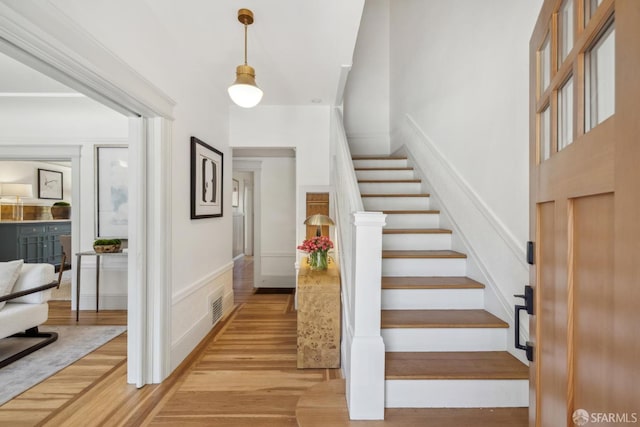 1383 8th Ave, San Francisco, CA 94122 - stairway with a decorative wall, wood finished floors, and a wainscoted wall