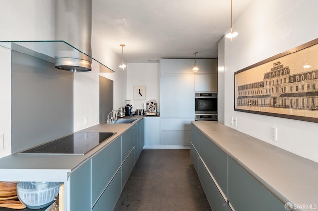 kitchen with black electric stovetop, a peninsula, a sink, hanging light fixtures, and modern cabinets