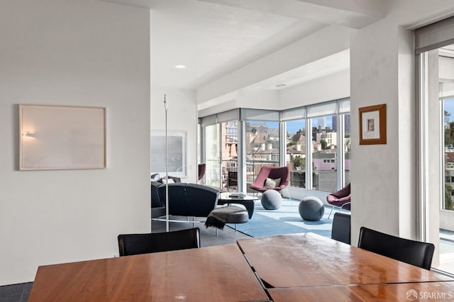 carpeted dining room with a city view