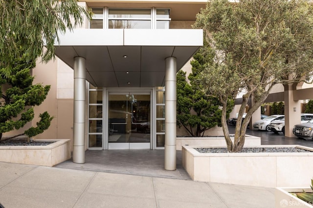 entrance to property with a balcony and stucco siding