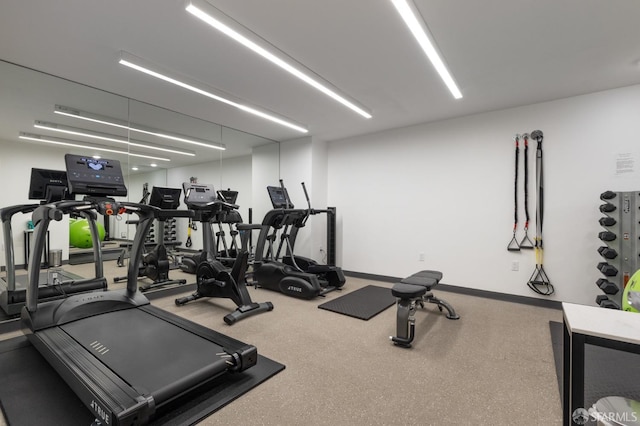 workout area featuring baseboards