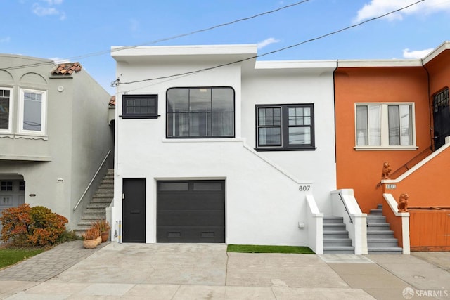 807 Vienna St, San Francisco, CA 94112 - view of front facade with stairway, stucco siding, and an attached garage