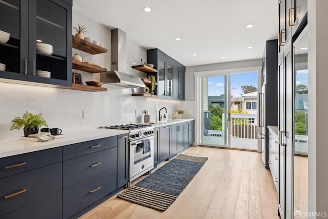 807 Vienna St, San Francisco, CA 94112 - kitchen with stainless steel stove, island exhaust hood, open shelves, light wood-style flooring, and backsplash