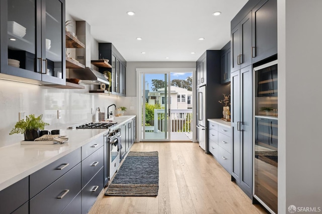 807 Vienna St, San Francisco, CA 94112 - kitchen with high quality appliances, light wood-style floors, beverage cooler, open shelves, and tasteful backsplash