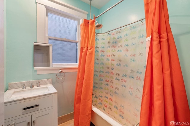 bathroom with shower / tub combo with curtain and vanity