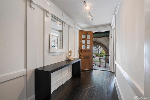 foyer entrance featuring track lighting and dark hardwood / wood-style floors