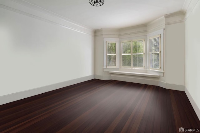 spare room with crown molding and dark hardwood / wood-style flooring