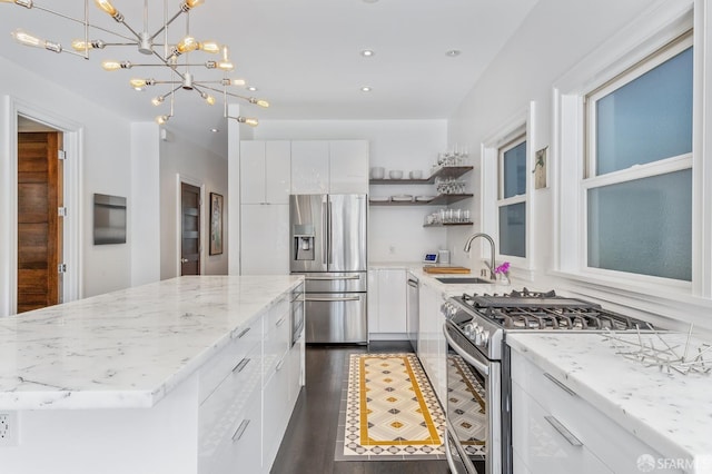 kitchen featuring white cabinets, appliances with stainless steel finishes, and sink