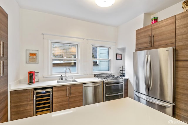 kitchen with wine cooler, stainless steel appliances, and sink