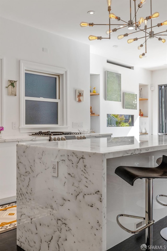 kitchen featuring light stone counters, decorative light fixtures, and a chandelier