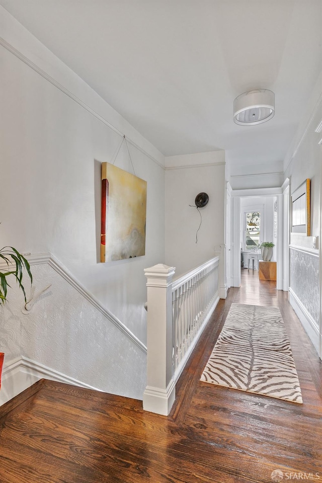 hall featuring crown molding and dark hardwood / wood-style flooring