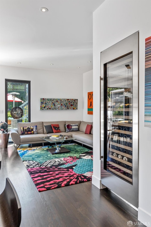 living room featuring wine cooler and dark hardwood / wood-style flooring