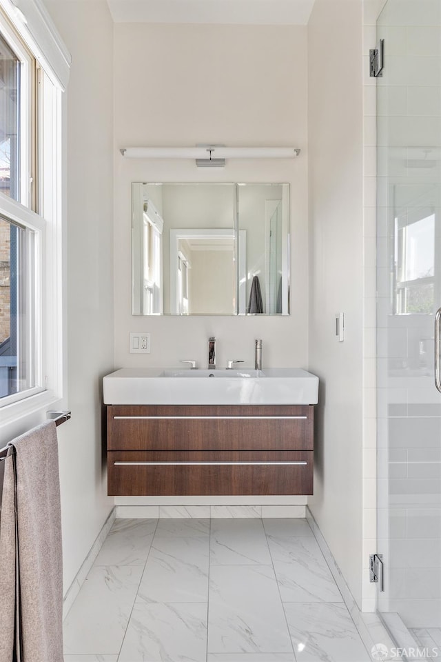 bathroom with walk in shower and vanity