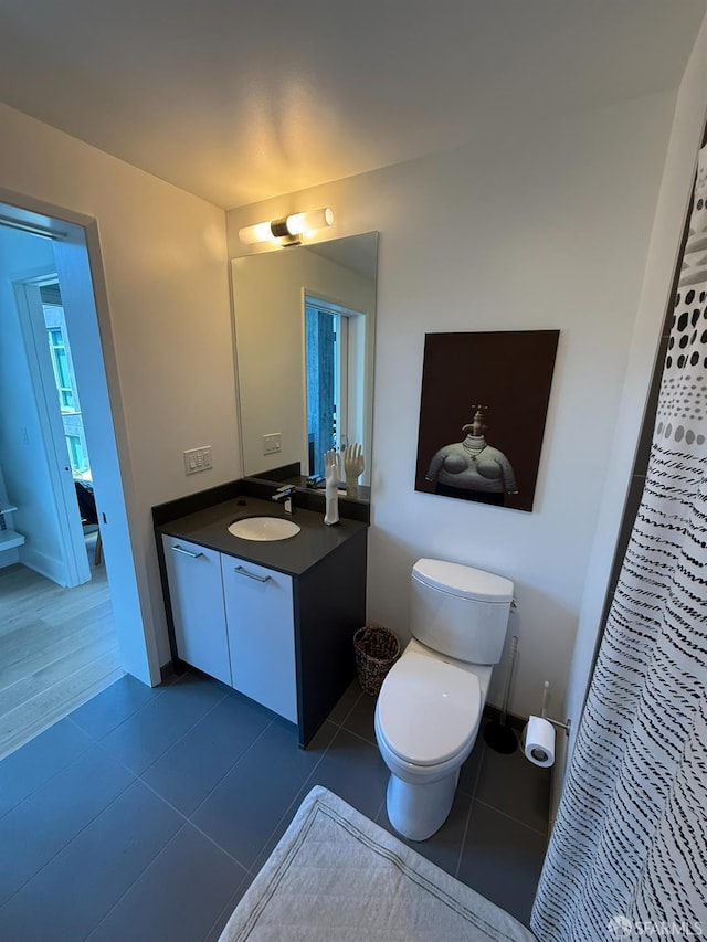 1075 Market St Unit 810, San Francisco, CA 94103 - full bathroom featuring vanity, toilet, tile patterned floors, and curtained shower
