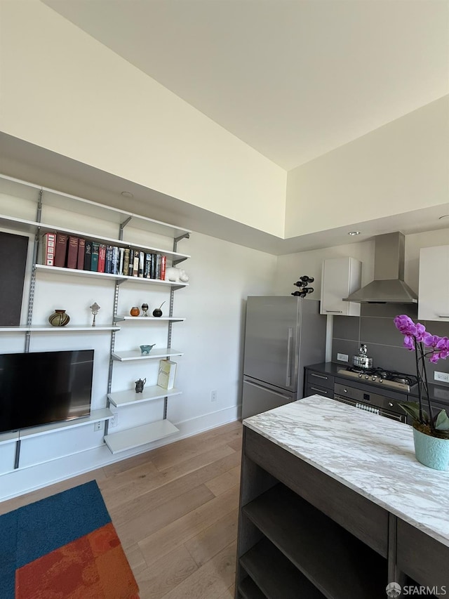 1075 Market St Unit 810, San Francisco, CA 94103 - kitchen featuring wall chimney exhaust hood, high quality fridge, open shelves, light wood-type flooring, and baseboards