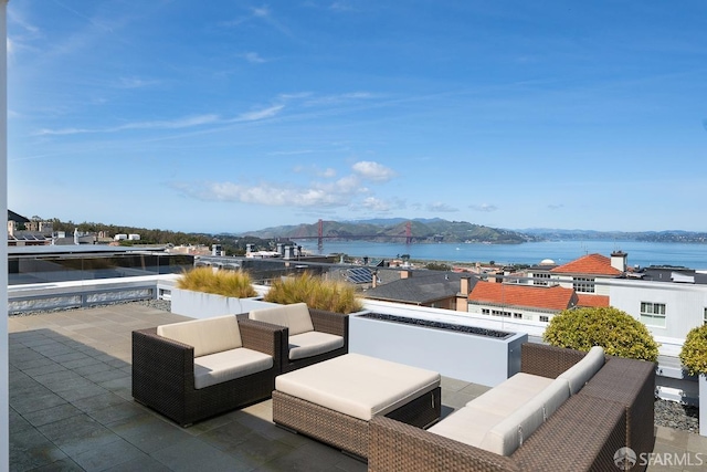 view of patio with outdoor lounge area and a water view