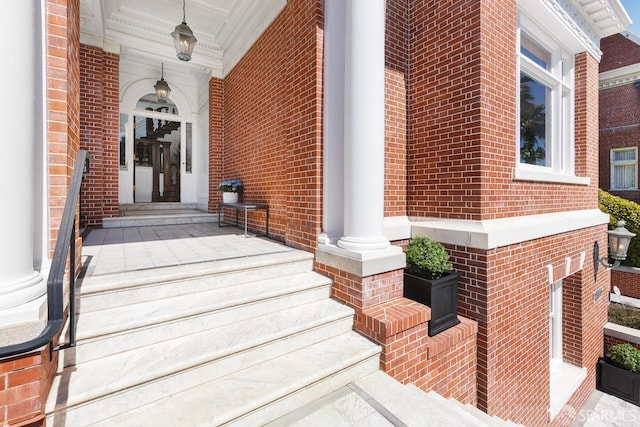 entrance to property with brick siding and a porch