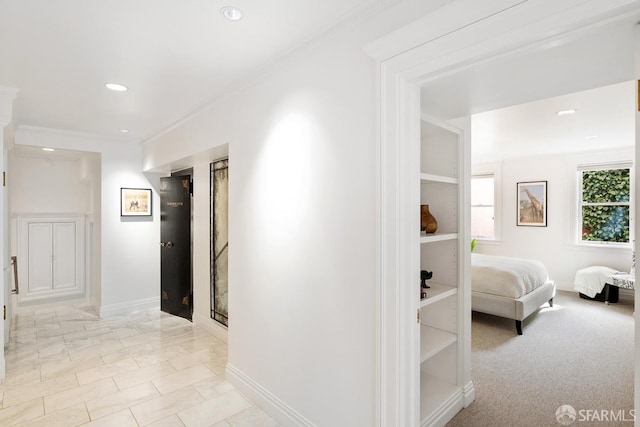 hallway featuring baseboards, ornamental molding, and recessed lighting