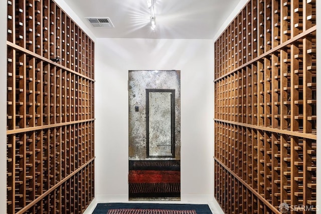 wine cellar featuring baseboards and visible vents