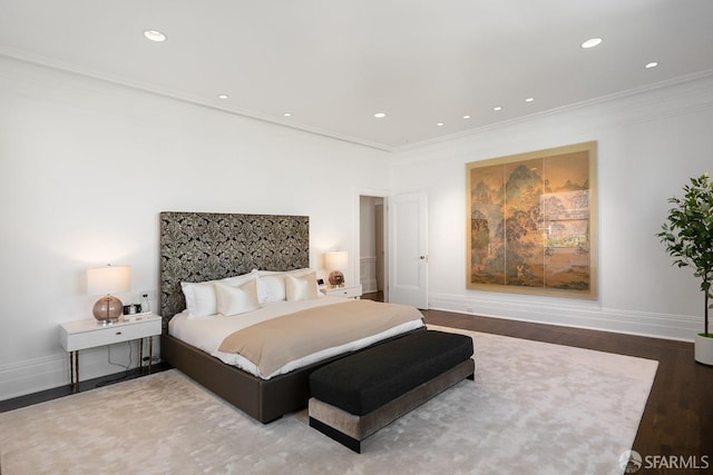 bedroom with recessed lighting, wood finished floors, baseboards, and ornamental molding