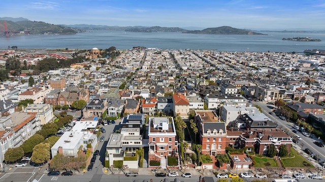 drone / aerial view featuring a water and mountain view
