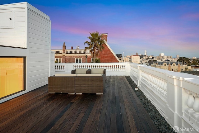 deck at dusk featuring outdoor lounge area